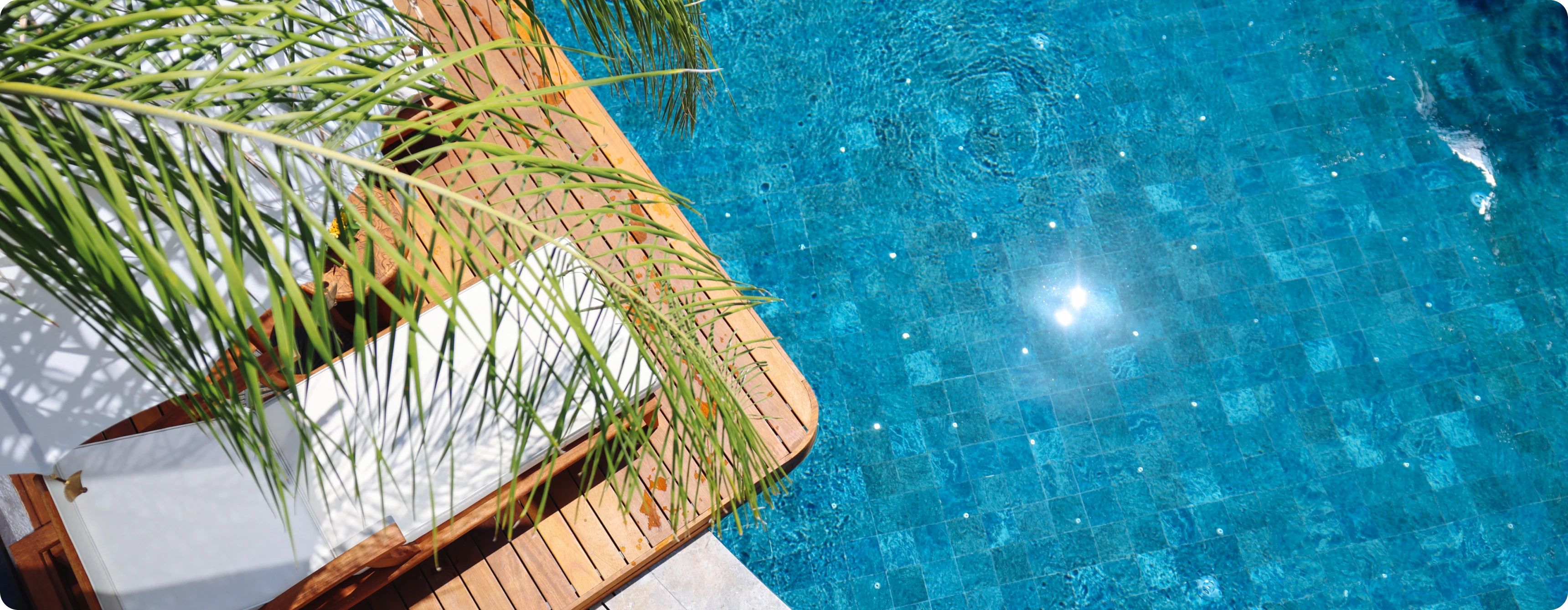 Poolside deck with palm leaves